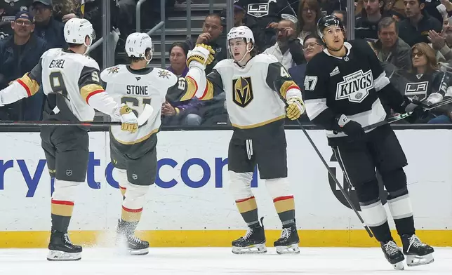 Vegas Golden Knights right wing Braeden Bowman (42) is greeted by Vegas Golden Knights right wing Mark Stone (61) after scoring against the Los Angeles Kings during the second period of an NHL hockey game Wednesday, Jan. 14, 2026, in Los Angeles. (AP Photo/Caroline Brehman)