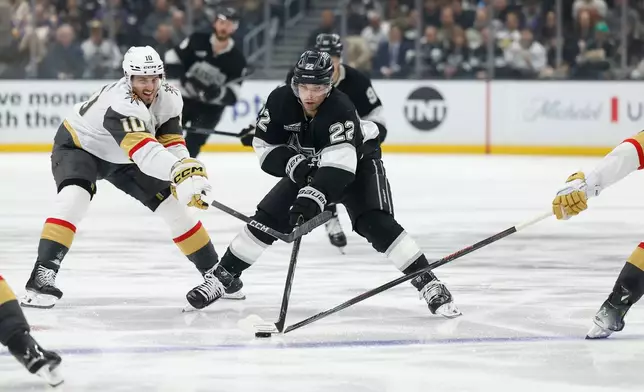 Vegas Golden Knights center Colton Sissons (10), Los Angeles Kings left wing Kevin Fiala (22) and Vegas Golden Knights defenseman Zach Whitecloud (2) fight for possession of the puck during the second period of an NHL hockey game Wednesday, Jan. 14, 2026, in Los Angeles. (AP Photo/Caroline Brehman)