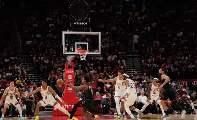 Play continues with the shot clock not working during the first half of an NBA basketball game between the Phoenix Suns and Houston Rockets Monday, Jan. 5, 2026, in Houston. (AP Photo/David J. Phillip)