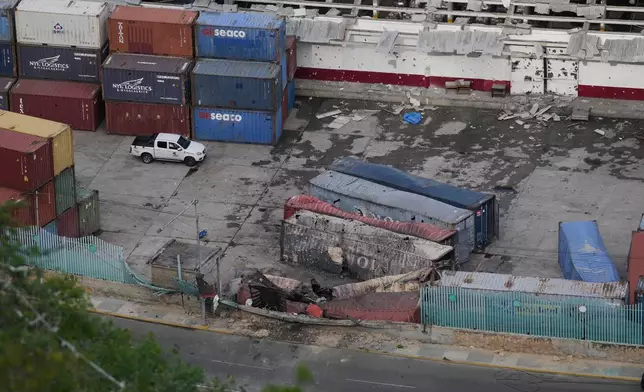 Destroyed containers lay at La Guaira port after explosions were heard in Venezuela, Saturday, Jan. 3, 2026. (AP Photo/Matias Delacroix)