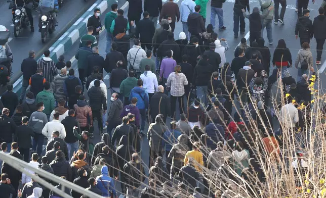 Protesters march in downtown Tehran, Iran, Monday, Dec. 29, 2025. (Fars News Agency via AP)