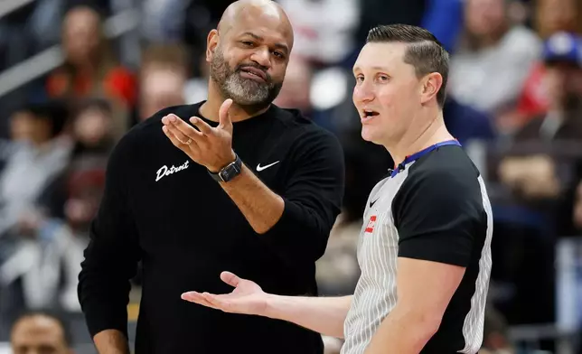 Detroit Pistons head coach J.B. Bickerstaff, left, talks with referee Ed Malloy during the first half of an NBA basketball game against the Phoenix Suns Thursday, Jan. 15, 2026, in Detroit. (AP Photo/Duane Burleson)