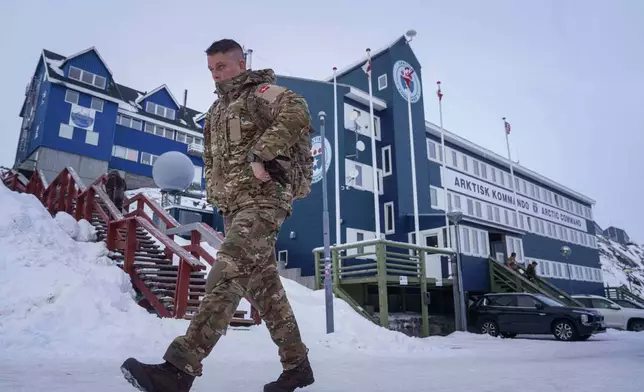 FILE - A Danish serviceman walks in front of Joint Arctic Command center in Nuuk, Greenland, on Jan. 16, 2026. (AP Photo/Evgeniy Maloletka, File)