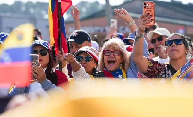 People gather to celebrate the deposing of Venezuelan President Nicolás Maduro, Sunday, Jan. 4, 2026, in Katy, Texas. (Elizabeth Conley/Houston Chronicle via AP)
