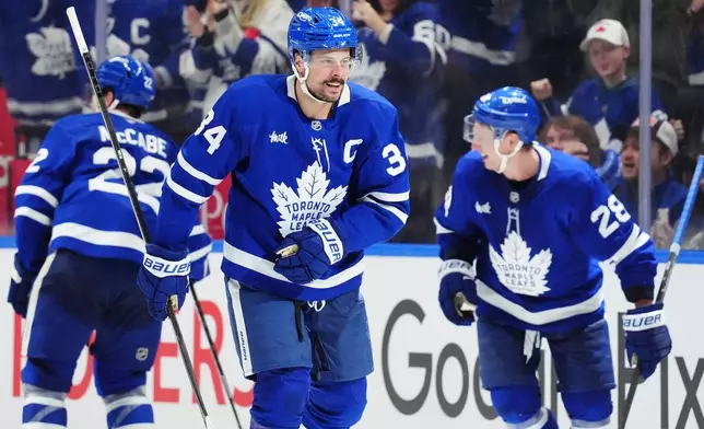 Toronto Maple Leafs' Auston Matthews (34) celebrates his goal against the Winnipeg Jets during the third period of an NHL hockey game in Toronto on Thursday, Jan. 1, 2026. (Frank Gunn/The Canadian Press via AP)