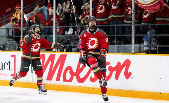 Ottawa Charge's Ronja Savolainen, right, celebrates after her goal against Vancouver Goldeneyes goaltender Kristen Campbell (not shown) during first-period PWHL hockey game action in Ottawa, Ontario, Friday, Jan. 9, 2026. (Spencer Colby/The Canadian Press via AP)