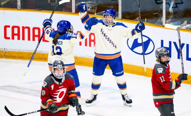 Vancouver Goldeneyes' Sophie Jaques, right, celebrates after her goal against the Ottawa Charge during third-period PWHL hockey game action in Ottawa, Ontario, Friday, Jan. 9, 2026. (Spencer Colby/The Canadian Press via AP)