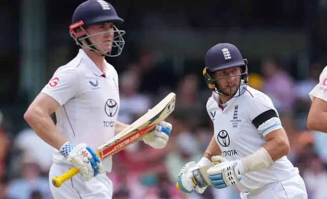 England's Joe Root runs between the wickets with teammate Harry Brook, left, during play on day one of the fifth and final Ashes cricket test between England and Australia in Sydney, Sunday, Jan. 4, 2026. (AP Photo/Mark Baker)
