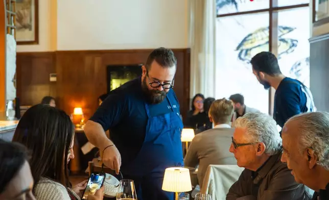 The chef serving the dishes to guests