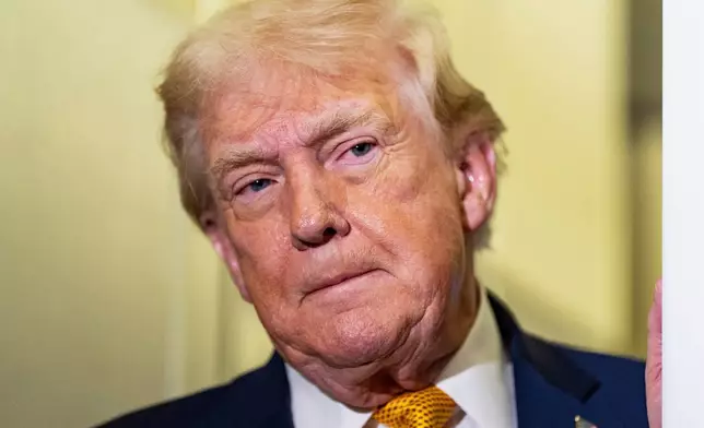 President Donald Trump listens as he was speaking with reporters while in flight on Air Force One, Sunday, Jan. 4, 2026, as returning to Joint Base Andrews, Md. (AP Photo/Alex Brandon)