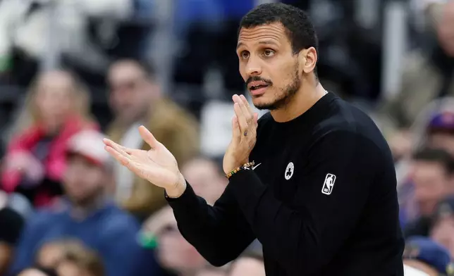 Boston Celtics head coach Joe Mazzulla applauds his team during a timeout against the Detroit Pistons during the first half of an NBA basketball game Monday, Jan. 19, 2026, in Detroit. (AP Photo/Duane Burleson)