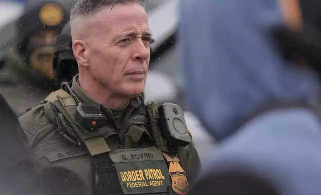 U.S. Border Patrol Cmdr. Gregory Bovino stands with Federal agents outside a convenience store on Wednesday, Jan. 21, 2026, in Minneapolis. (AP Photo/Angelina Katsanis)
