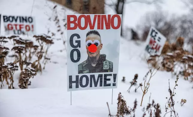 A poster reading "Bovino Go Home," featuring an altered image of U.S. Border Patrol Cmdr. Gregory Bovino, is displayed in the snow outside a home on Wednesday, Jan. 21, 2026, in Minneapolis. (Kerem Yücel/Minnesota Public Radio via AP)