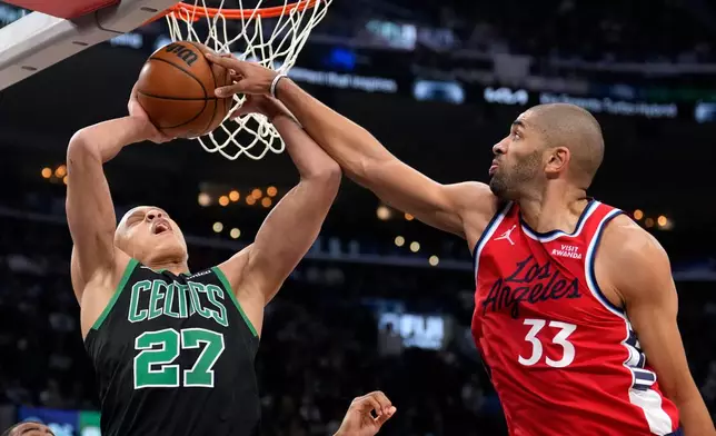 Boston Celtics guard Jordan Walsh, left, has his shot blocked by Los Angeles Clippers forward Nicolas Batum during the first half of an NBA basketball game Saturday, Jan. 3, 2026, in Inglewood, Calif. (AP Photo/Mark J. Terrill)