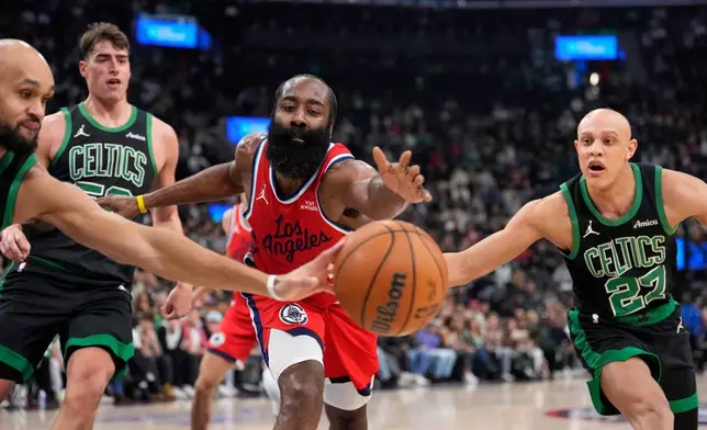 Boston Celtics forward Josh Minott, left, guard Jordan Walsh, right and Los Angeles Clippers guard James Harden, second from left, reach for a loose ball during the first half of an NBA basketball game Saturday, Jan. 3, 2026, in Inglewood, Calif. (AP Photo/Mark J. Terrill)
