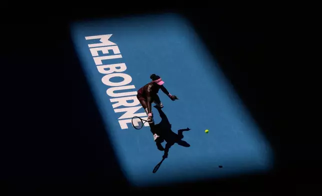 Victoria Mboko of Canada plays a forehand return to Clara Tauson of Denmark during their third round match at the Australian Open tennis championship in Melbourne, Australia, Friday, Jan. 23, 2026. (AP Photo/Aaron Favila)