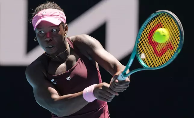 Victoria Mboko of Canada plays a backhand return to Clara Tauson of Denmark during their third round match at the Australian Open tennis championship in Melbourne, Australia, Friday, Jan. 23, 2026. (AP Photo/Aaron Favila)