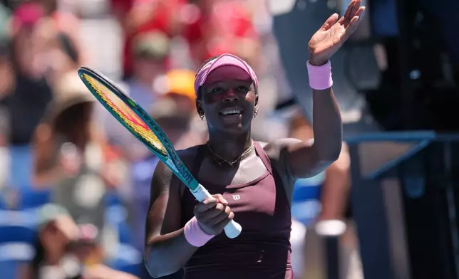 Victoria Mboko of Canada waves after defeating Clara Tauson of Denmark in their third round match at the Australian Open tennis championship in Melbourne, Australia, Friday, Jan. 23, 2026. (AP Photo/Aaron Favila)