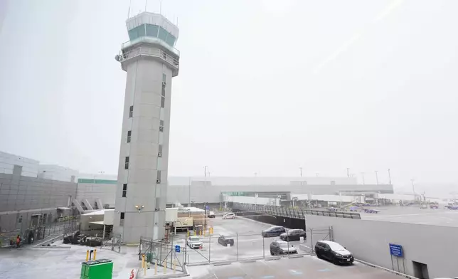 The control tower at Love Field Airport is shown where weather conditions have had an impact on travel in and out of the normally busy airport Saturday, Jan. 24, 2026, in Dallas. (AP Photo/Tony Gutierrez)