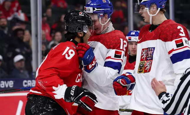 Canada defense Zayne Parekh, left, and Czechia forward Maxmilian Curran (12) exchange words during the second period of an IIHF World Junior Hockey Championship semifinals game, Sunday, Jan. 4, 2026, in St. Paul, Minn. (AP Photo/Matt Krohn)
