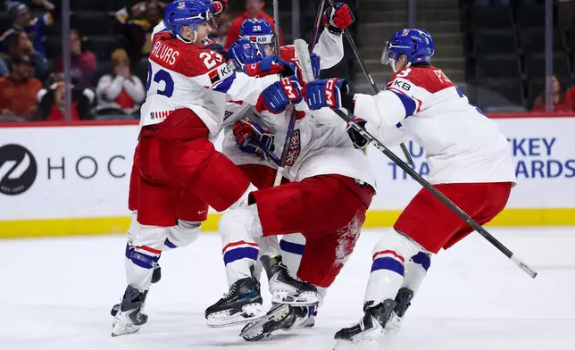 Czechia forward Tomas Poletin celebrates his go ahead goal with teammates during the third period of an IIHF World Junior Hockey Championship semifinals game against Canada, Sunday, Jan. 4, 2026, in St. Paul, Minn. (AP Photo/Matt Krohn)