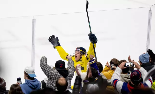 Sweden's Anton Frondell celebrates after scoring on Finland goaltender Petteri Rimpinen during overtime shoot-out in a semifinal IIHF World Junior Hockey Championship game in St. Paul, Minn., Sunday, Jan. 4, 2026. (Christopher Katsarov/The Canadian Press via AP)