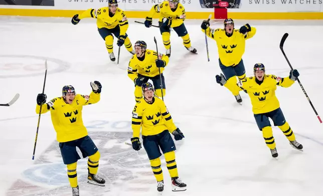 Team Sweden players celebrate after Anton Frondell scored on Finland goaltender Petteri Rimpinen during overtime shoot-out in an IIHF World Junior Hockey Championship semifinals game in St. Paul, Minn., Sunday, Jan. 4, 2026. (Christopher Katsarov/The Canadian Press via AP)