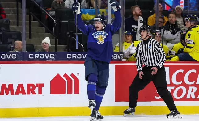 Finland forward Atte Joki (35) celebrates his goal against Sweden during the first period of an IIHF World Junior Hockey Championship semifinals game, Sunday, Jan. 4, 2026, in St. Paul, Minn. (AP Photo/Matt Krohn)