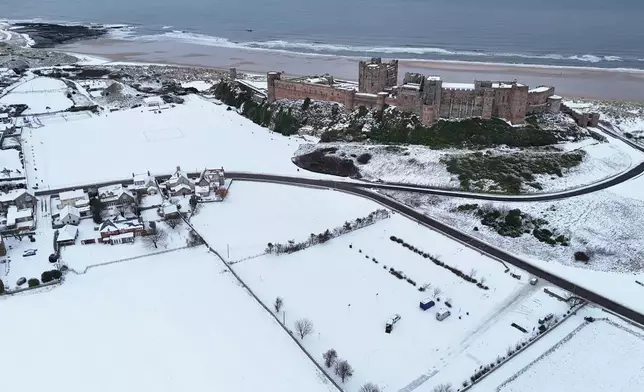 Bamburgh Castle surrounded by snow in Bamburgh, England, Tuesday, Jan. 6, 2026. (Owen Humphreys/PA via AP)