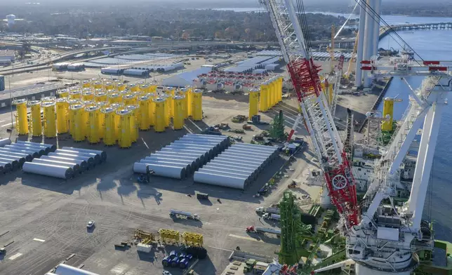 FILE - Wind turbine bases, generators and blades sit along with support ships at The Portsmouth Marine terminal that is the staging area for Dominion Energy Virginia, which is developing Coastal Virginia Offshore Wind, Dec. 22, 2025, in Portsmouth, Va. (AP Photo/Steve Helber, File)