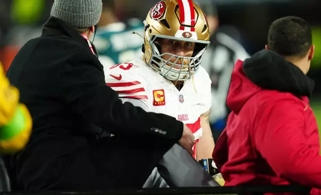 San Francisco 49ers tight end George Kittle (85) is carted off the field after an injury during the first half of an NFL wild-card playoff football game against the Philadelphia Eagles on Sunday, Jan. 11, 2026, in Philadelphia. (AP Photo/Derik Hamilton)