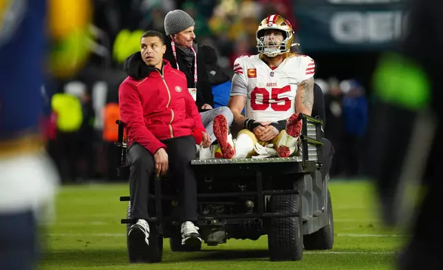 San Francisco 49ers tight end George Kittle (85) is carted off the field after an injury during the first half of an NFL wild-card playoff football game against the Philadelphia Eagles on Sunday, Jan. 11, 2026, in Philadelphia. (AP Photo/Derik Hamilton)