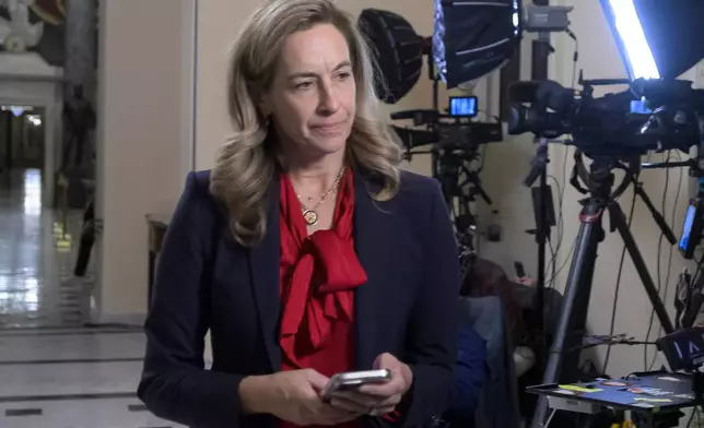 FILE - New Jersey Gov.-elect Rep. Mikie Sherrill, D-N.J., left, prepares for a television interview at the U.S. Capitol, Wednesday, Nov. 12, 2025, in Washington. (AP Photo/Rod Lamkey, Jr., File)