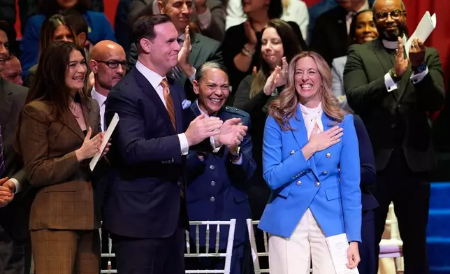 People stand and applaud for New Jersey Governor Mikie Sherrill during her inauguration ceremony in Newark, N.J., Tuesday, Jan. 20, 2026. (AP Photo/Seth Wenig)