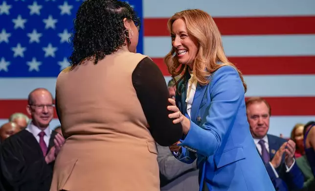 New Jersey Governor-elect Mikie Sherrill greets supporters as she arrives for her inauguration, Tuesday, Jan. 20, 2026, in Newark, N.J. (AP Photo/Seth Wenig)