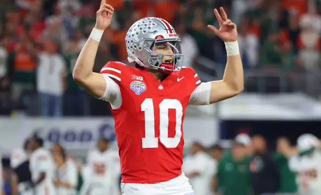 Ohio State quarterback Julian Sayin reacts after throwing a touchdown pass against Miami during the second half of the Cotton Bowl College Football Playoff quarterfinal game Wednesday, Dec. 31, 2025, in Arlington, Texas. (AP Photo/Gareth Patterson)
