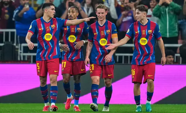 Barcelona players celebrate after scoring the second goal during the Spanish Super Cup semifinal soccer match against Athletic Club Bilbao at King Abdullah Sports City Stadium in Jeddah, Saudi Arabia, Wednesday, Jan. 7, 2026. (AP Photo/Altaf Qadri)