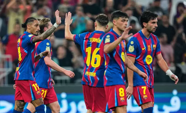 Barcelona players celebrate after scoring the fifth goal during the Spanish Super Cup semifinal soccer match against Athletic Club Bilbao at King Abdullah Sports City Stadium in Jeddah, Saudi Arabia, Wednesday, Jan. 7, 2026. (AP Photo/Altaf Qadri)