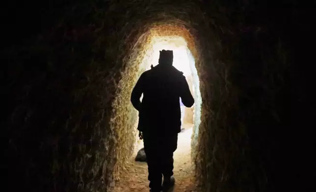 A member of Syrian security forces inspects a tunnel in the predominantly Kurdish Sheikh Maqsoud neighborhood, where clashes broke out Tuesday, Jan. 6, between government forces and the Kurdish-led Syrian Democratic Forces in the northern city of Aleppo, Syria, Monday, Jan. 12, 2026. (AP Photo/Omar Albam)