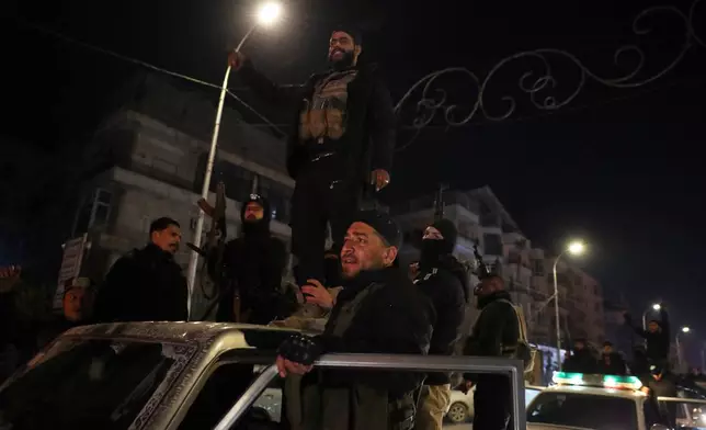 Members of Syrian government forces deploy on the streets as they take over the Achrafieh neighborhood from Kurdish fighters during ongoing clashes that erupted Tuesday in a contested area of the northern city of Aleppo, Syria, Thursday, Jan. 8, 2026. (AP Photo/Omar Albam)