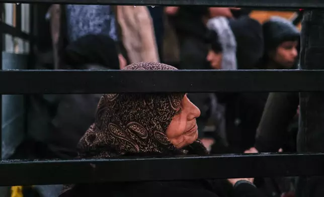 Residents flee the Sheikh Maqsoud neighborhood of Aleppo, Syria, Friday, Jan. 9, 2026, after the government declared the area a closed military zone following days of clashes between government forces and Kurdish fighters. (AP Photo/Ghaith Alsayed)