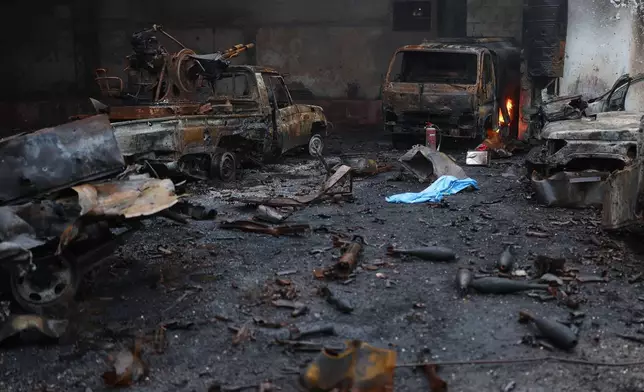 Burned vehicles and ammunitions left at one of the Kurdish fighters positions at the Sheikh Maqsoud neighborhood, where clashes between government forces and Kurdish fighters have been taking place in the northern city of Aleppo, Syria, Sunday, Jan. 11, 2026. (AP Photo/Ghaith Alsayed)