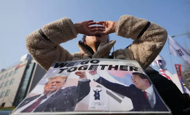 A supporter of former South Korean President Yoon Suk Yeol shouts slogans outside Seoul Central District Court, in Seoul, South Korea, Friday, Jan. 16, 2026. (AP Photo/Lee Jin-man)