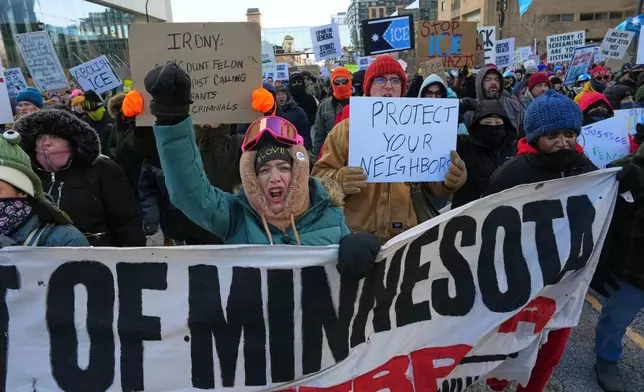 People protest against ICE (Immigration and Customs Enforcement) in downtown Minneapolis, Sunday, Jan. 25, 2026. (AP Photo/Adam Gray)