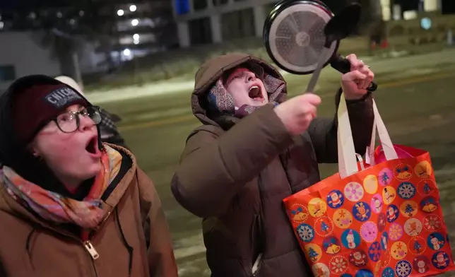 People take part in a noise demonstration protest in response to federal immigration enforcement operations in the city Sunday, Jan. 25, 2026, in Minneapolis. (AP Photo/Adam Gray)