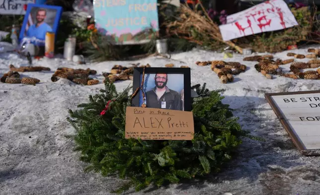A makeshift memorial is placed where Alex Pretti was fatally shot by a U.S. Border Patrol officer yesterday, in Minneapolis, Sunday, Jan. 25, 2026. (AP Photo/Adam Gray)