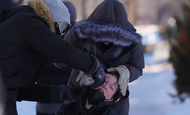 A person gets their eyes washed out after federal immigration officers deploy pepper spray Saturday, Jan. 24, 2026, in Minneapolis. (AP Photo/Abbie Parr)