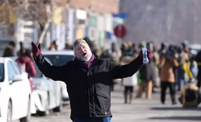 A person reacts to federal immigration officers after a shooting Saturday, Jan. 24, 2026, in Minneapolis. (AP Photo/Abbie Parr)