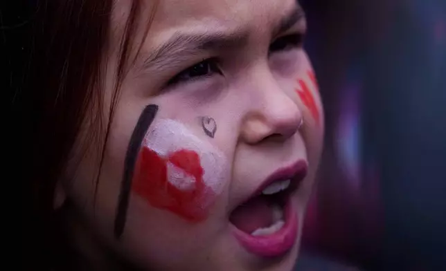A girl shouts during protest against Trump's policy towards Greenland in front of US consulate in Nuuk, Greenland, Saturday, Jan. 17, 2026. (AP Photo/Evgeniy Maloletka)