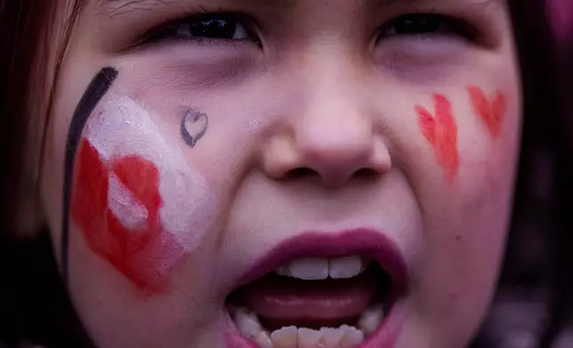A girl shouts during protest against Trump's policy towards Greenland in front of the US consulate in Nuuk, Greenland, Saturday, Jan. 17, 2026. (AP Photo/Evgeniy Maloletka)